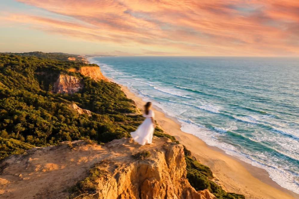 Composição aérea da linha de costa da Praia de Taípe revelando o relevo das falésias e o mar da Costa do Descobrimento, em Trancoso, Bahia