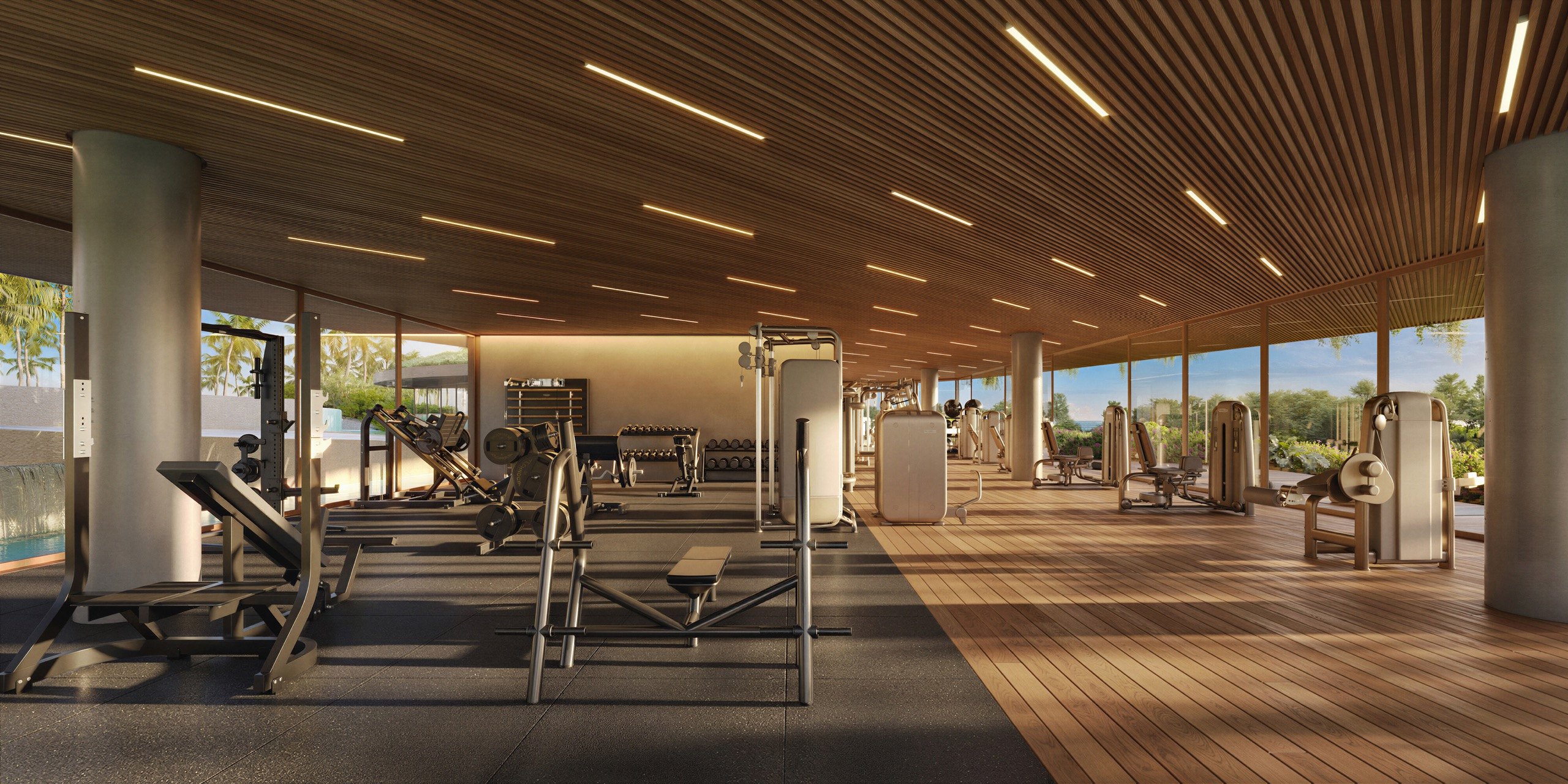 Interior da academia Fit House de Taípe, com equipamentos Technogym sob o forro de madeira e deck aberto para a mata, Trancoso · imagem meramente ilustrativa